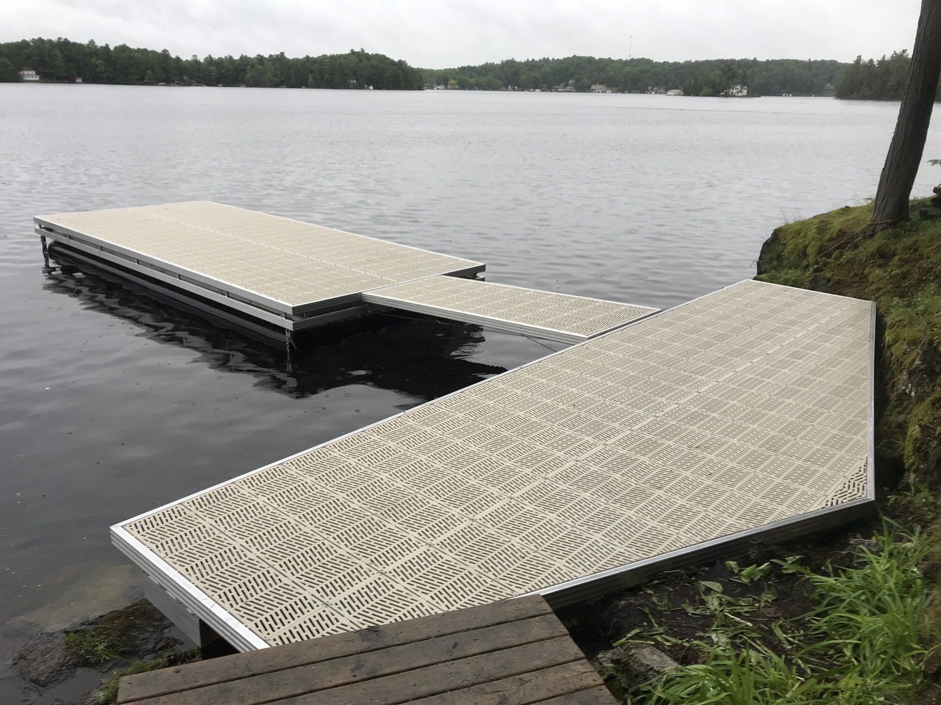 A dock is sitting on the shore of a lake.