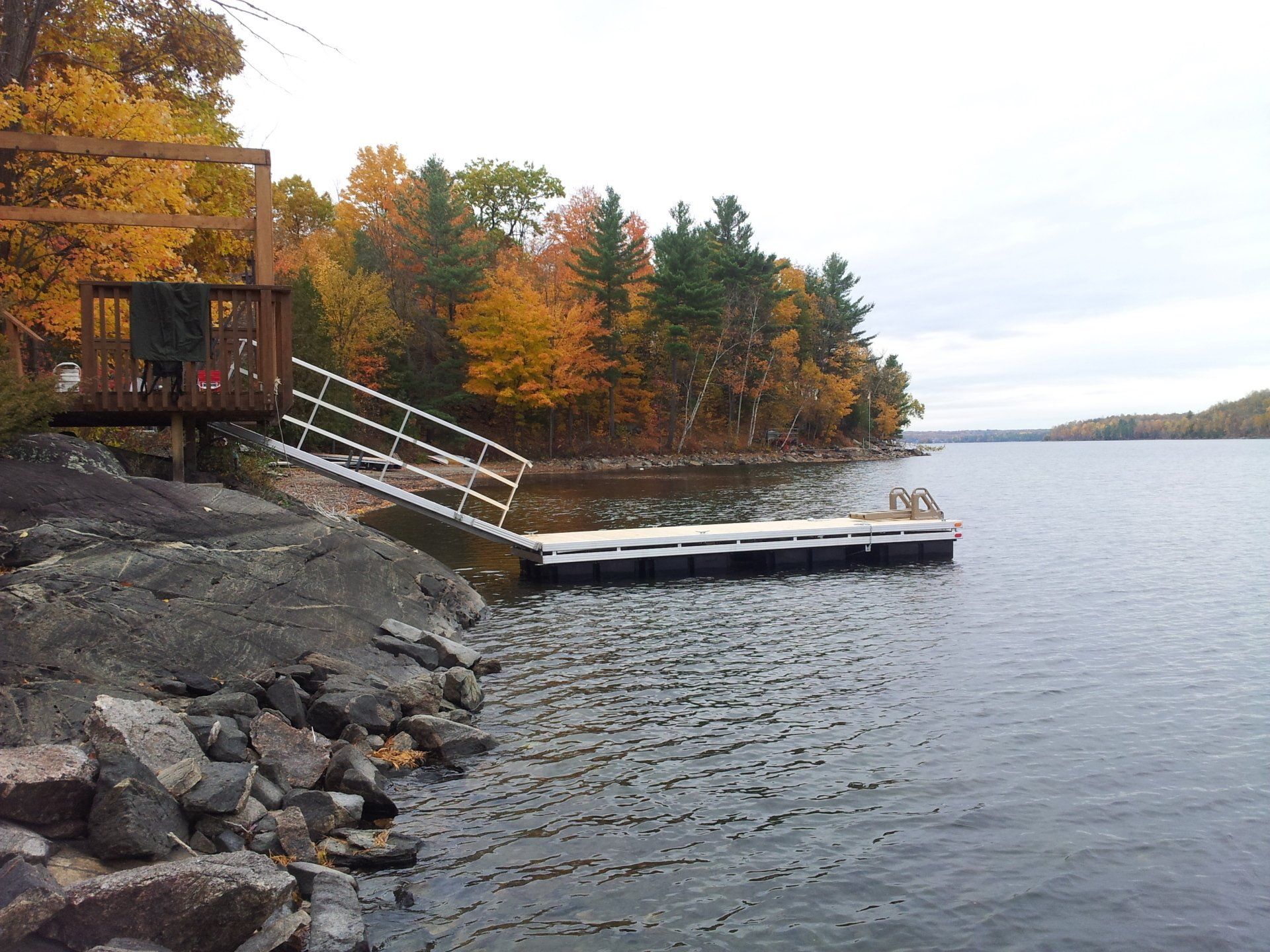 A large body of water with a dock in the middle of it