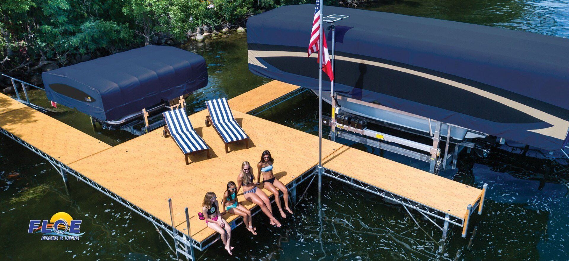 A group of people are sitting on a dock next to a boat.