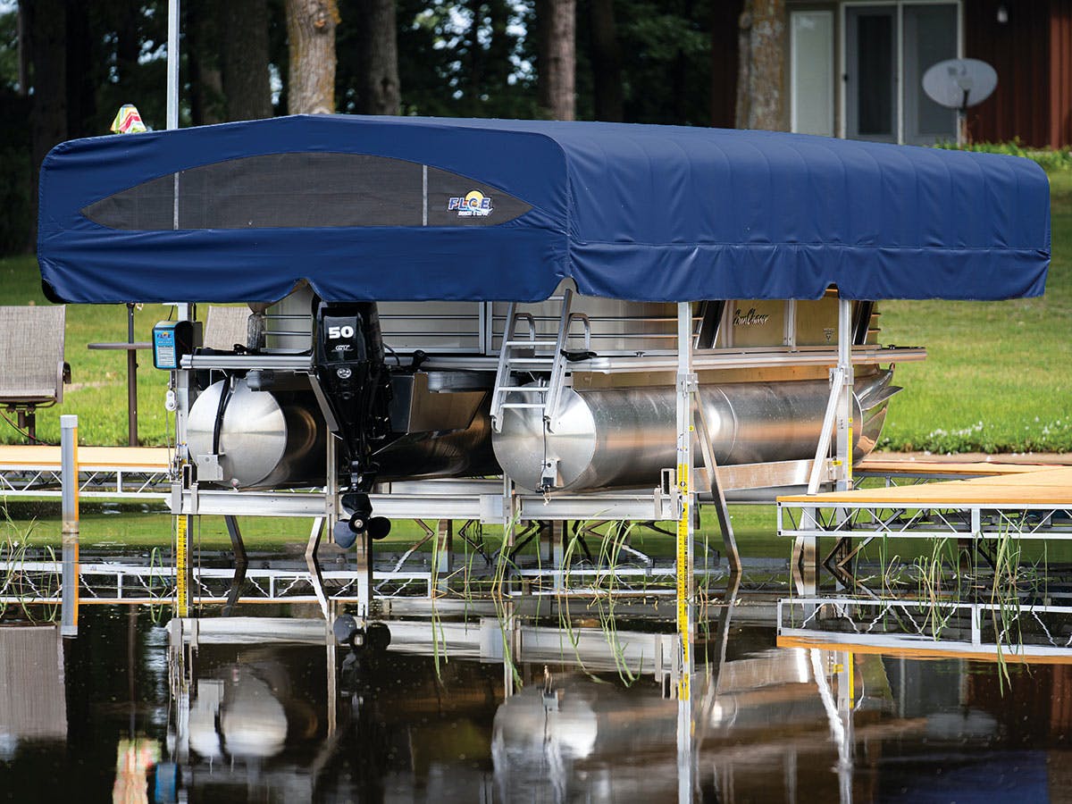 A boat is sitting on a dock with a blue canopy over it