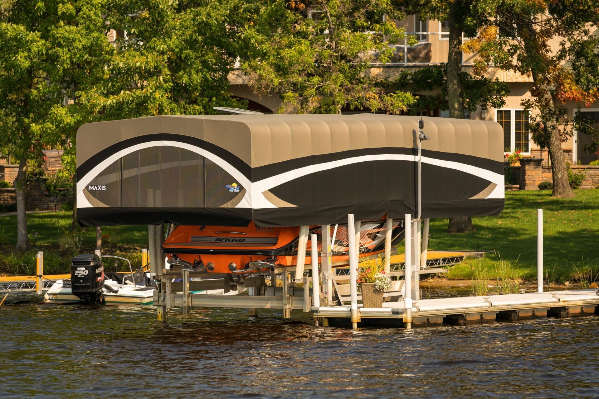A boat is sitting under a canopy on a dock.