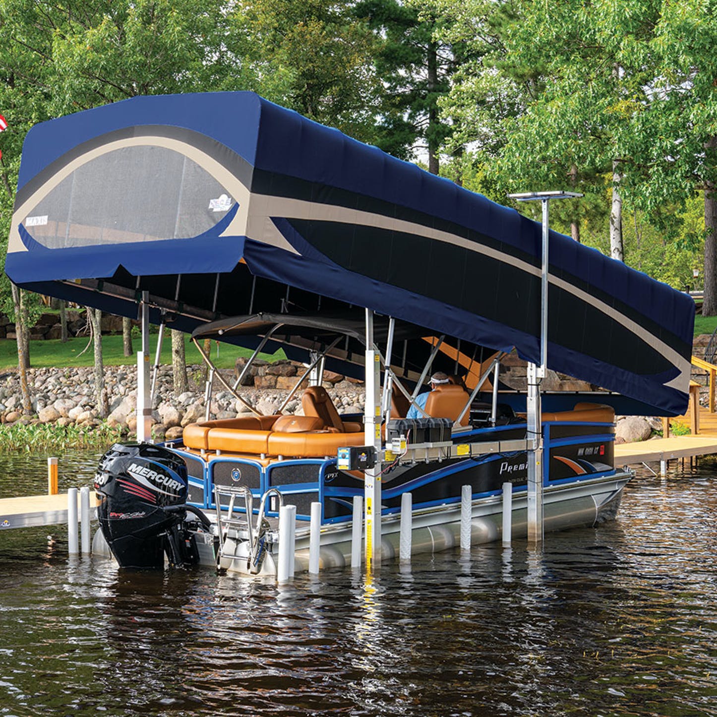 A pontoon boat is docked at a dock with a canopy over it