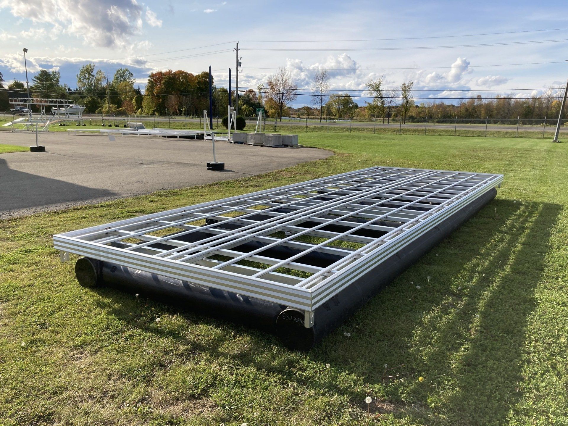 A large metal structure is sitting on top of a lush green field.