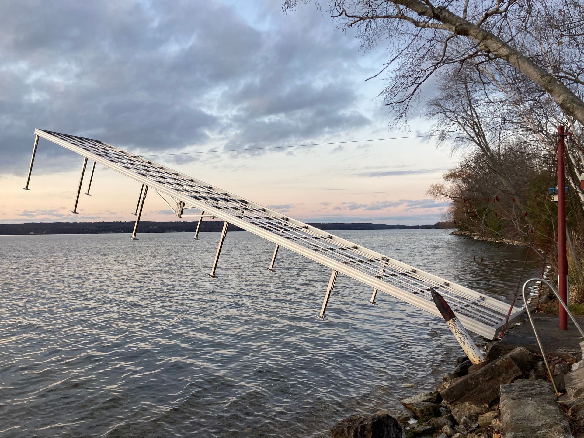 A ladder is leaning over a body of water.