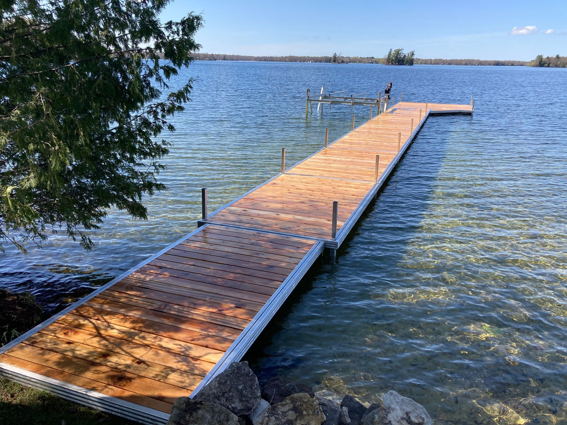 A wooden dock is sitting in the middle of a lake.