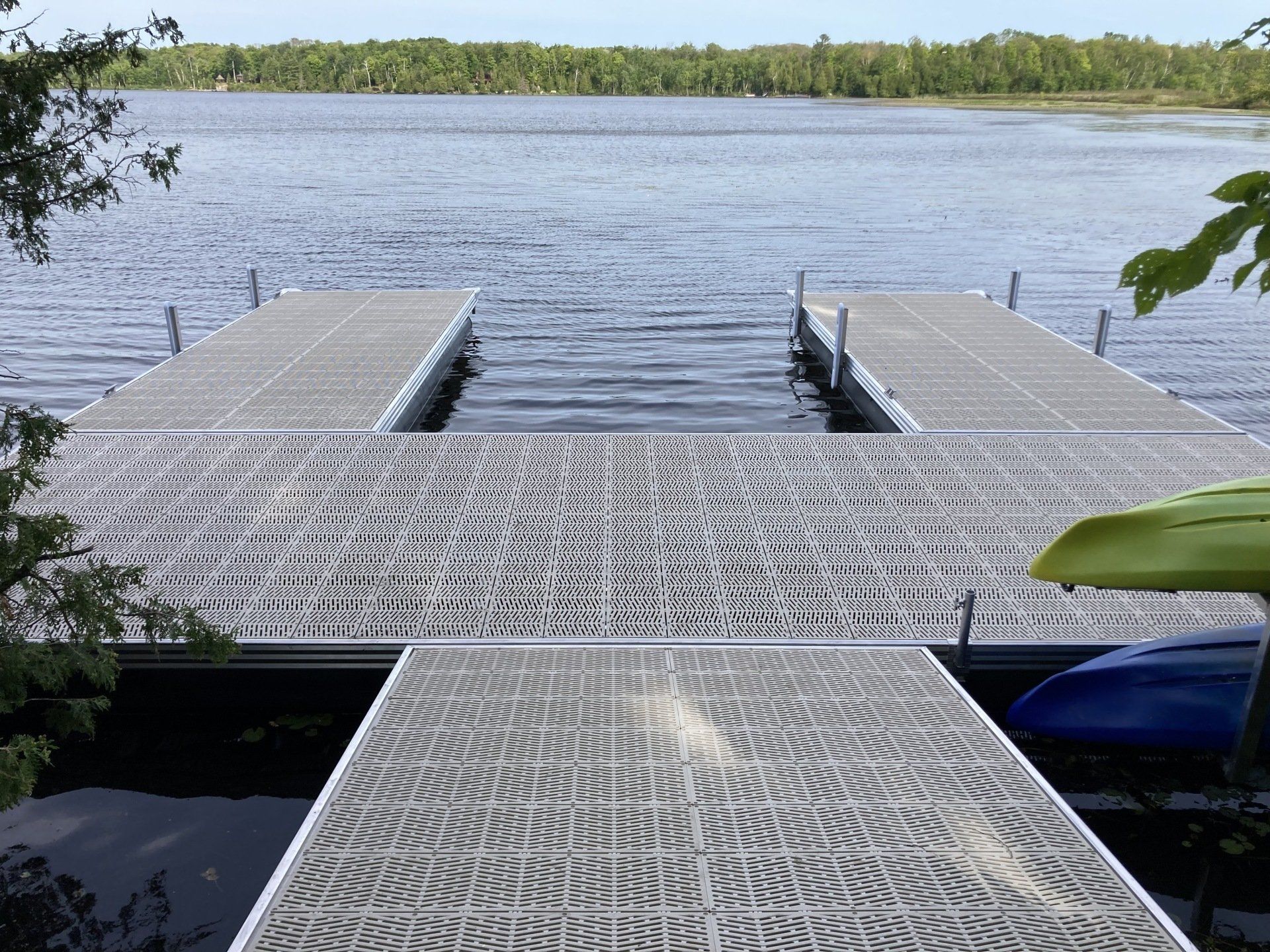 A large body of water with a dock in the foreground