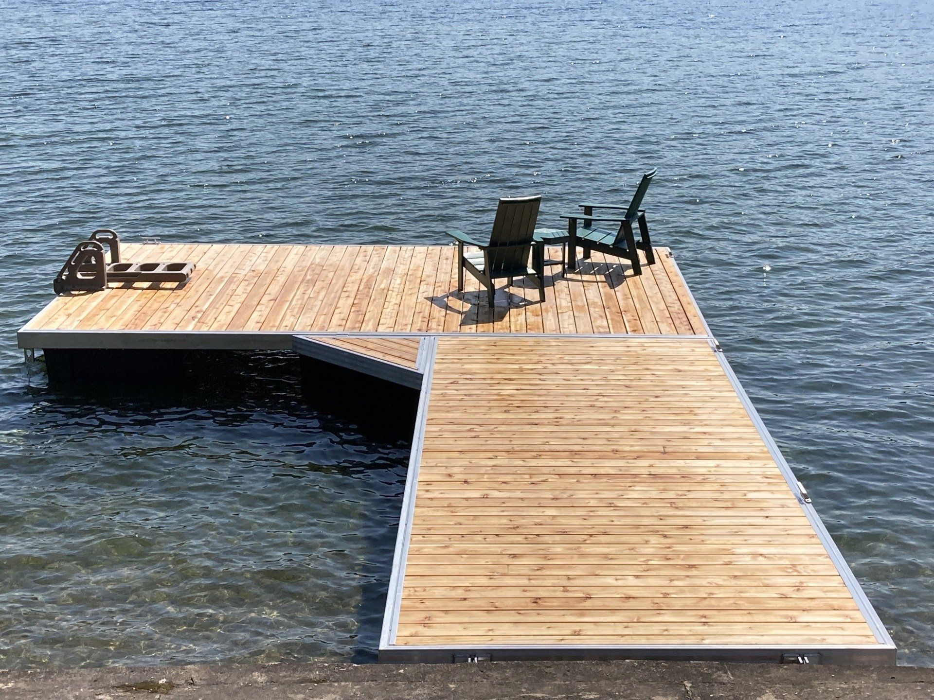 A wooden dock with chairs and a table in the water.