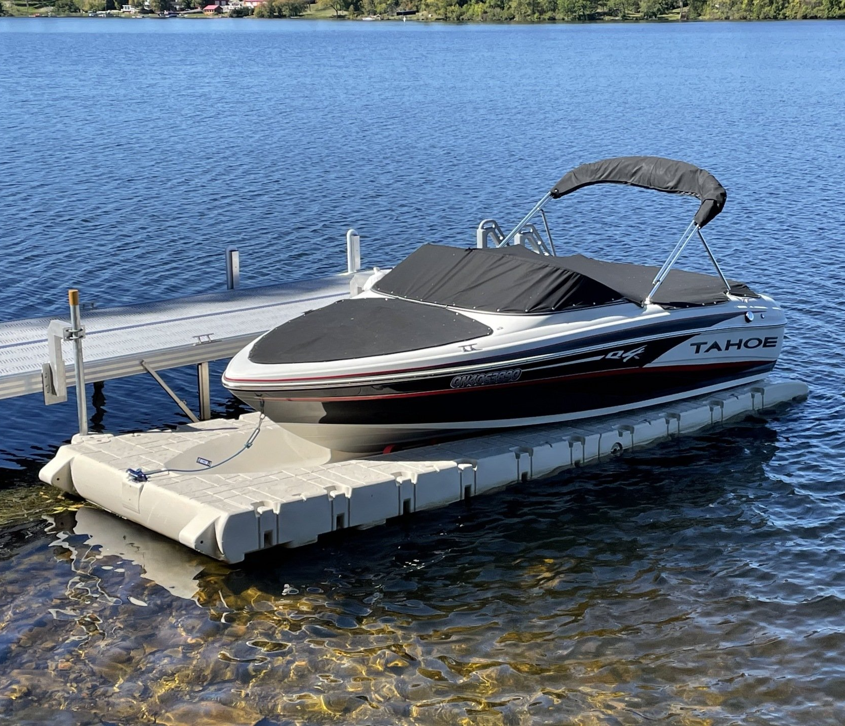 A boat is docked at a dock on a lake.