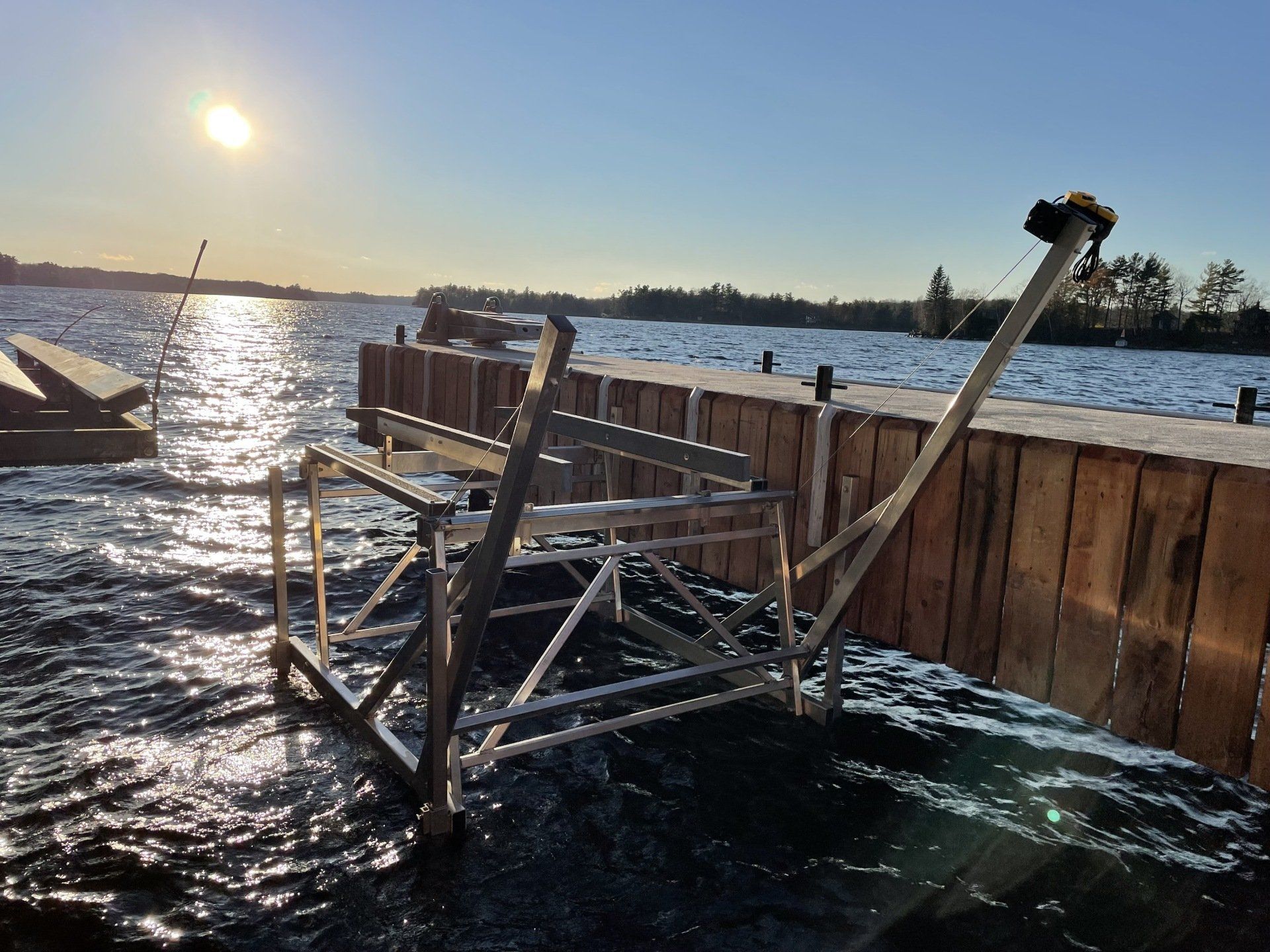 A dock with a chair on it in the water