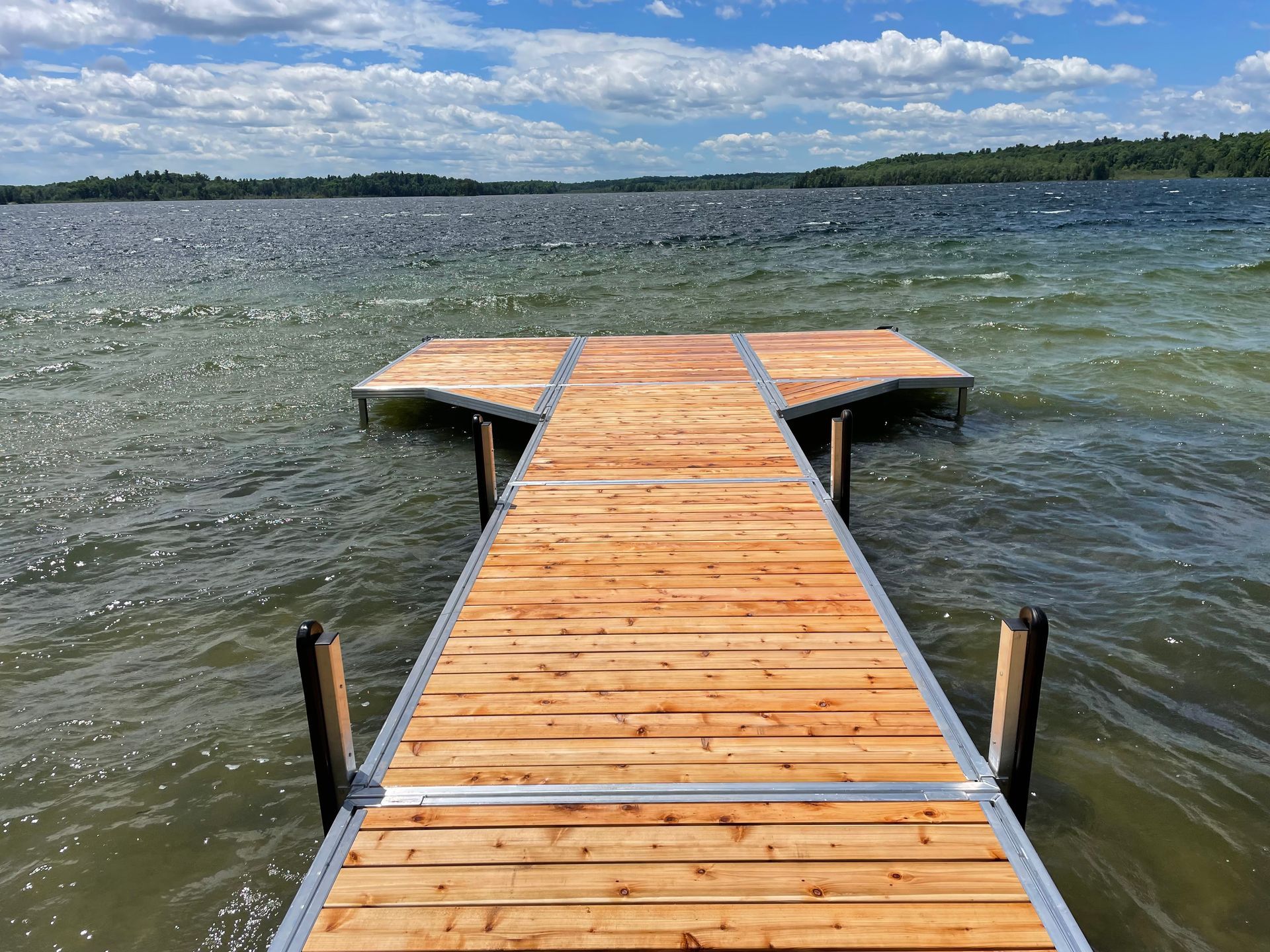 A wooden dock leading into a large body of water.