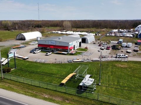 An aerial view of a large building with a lot of vehicles parked in front of it.