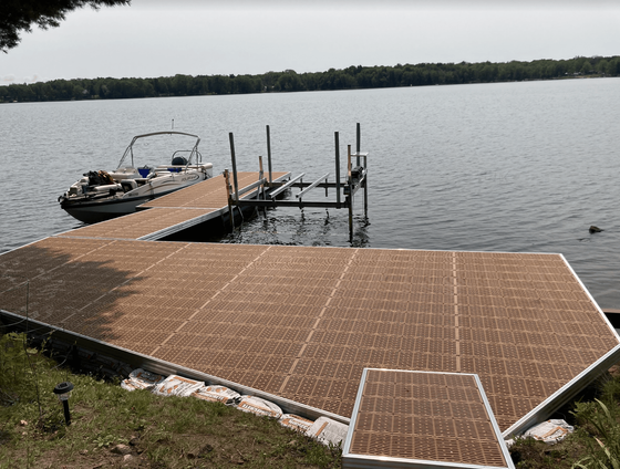A boat is docked at a dock on a lake.