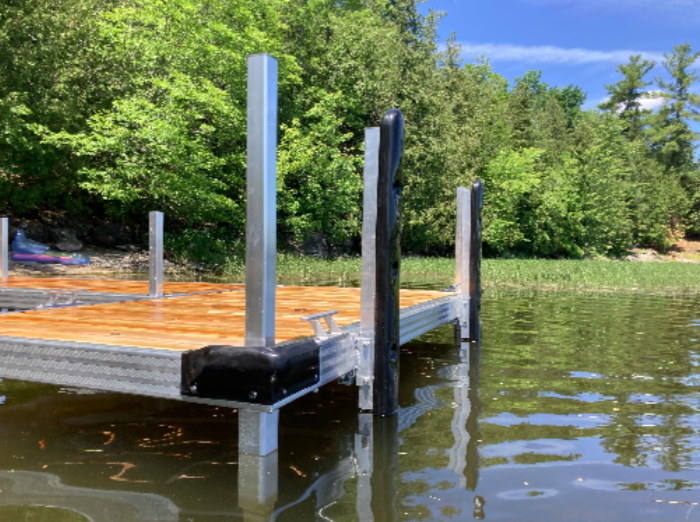 A wooden dock is sitting in the middle of a lake.