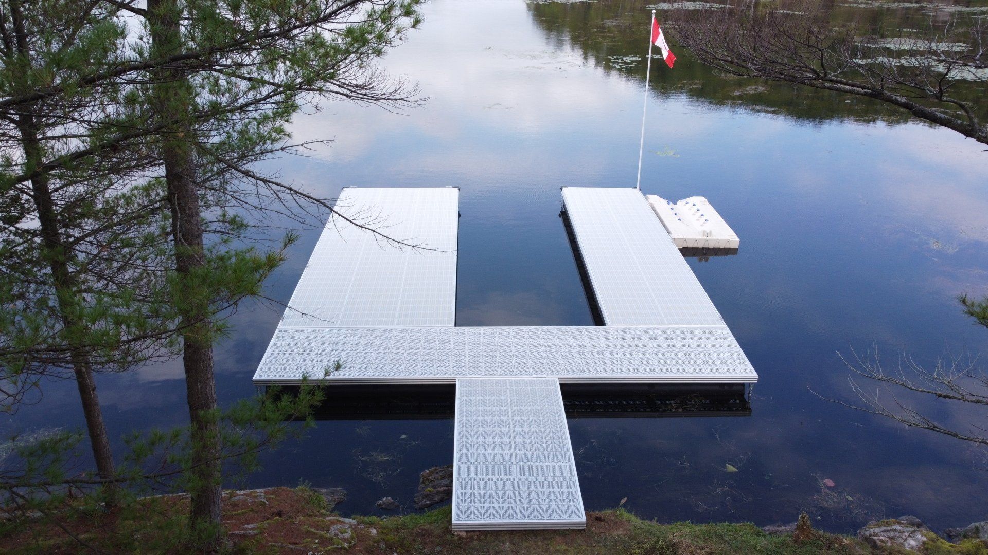 A large white dock is in the middle of a lake.
