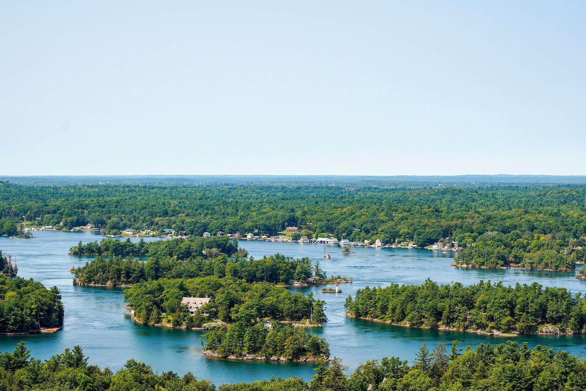Aerial view of wooded granite islands and blue water in the Thousand Islands on the St. Lawrence Riv