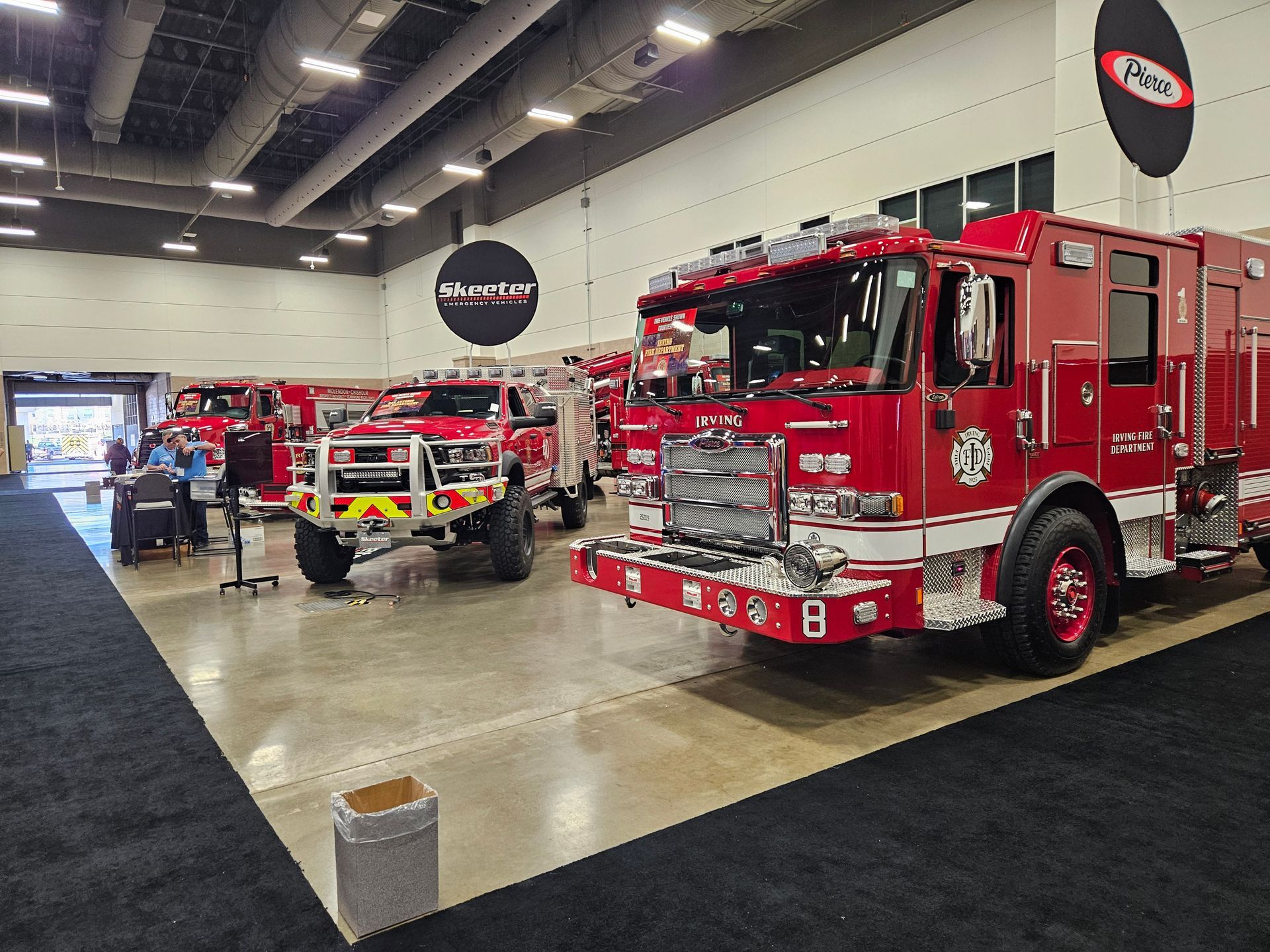 A fire truck is parked in a room with other fire trucks.