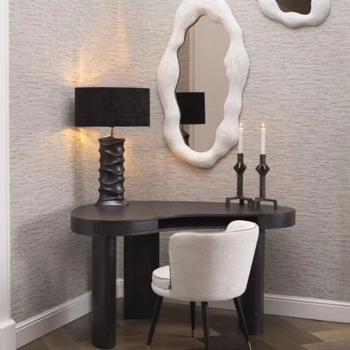 Een bureau met een lamp en twee kaarsen erop
