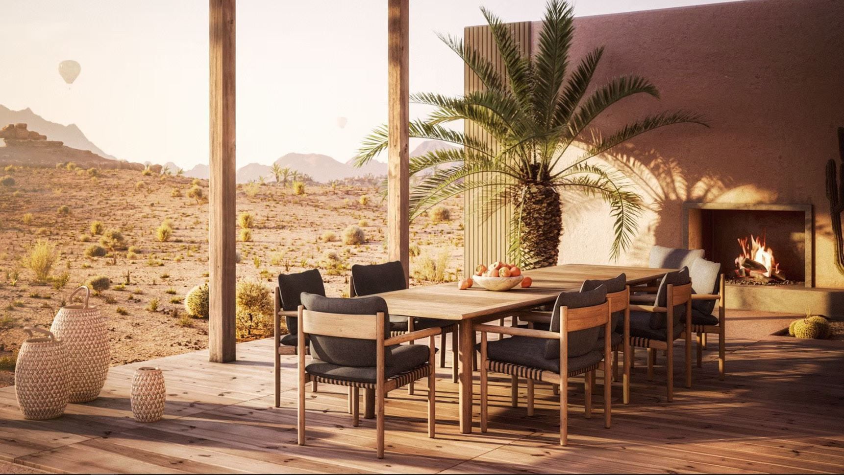 Een terras met een tafel, stoelen en een open haard in de woestijn.