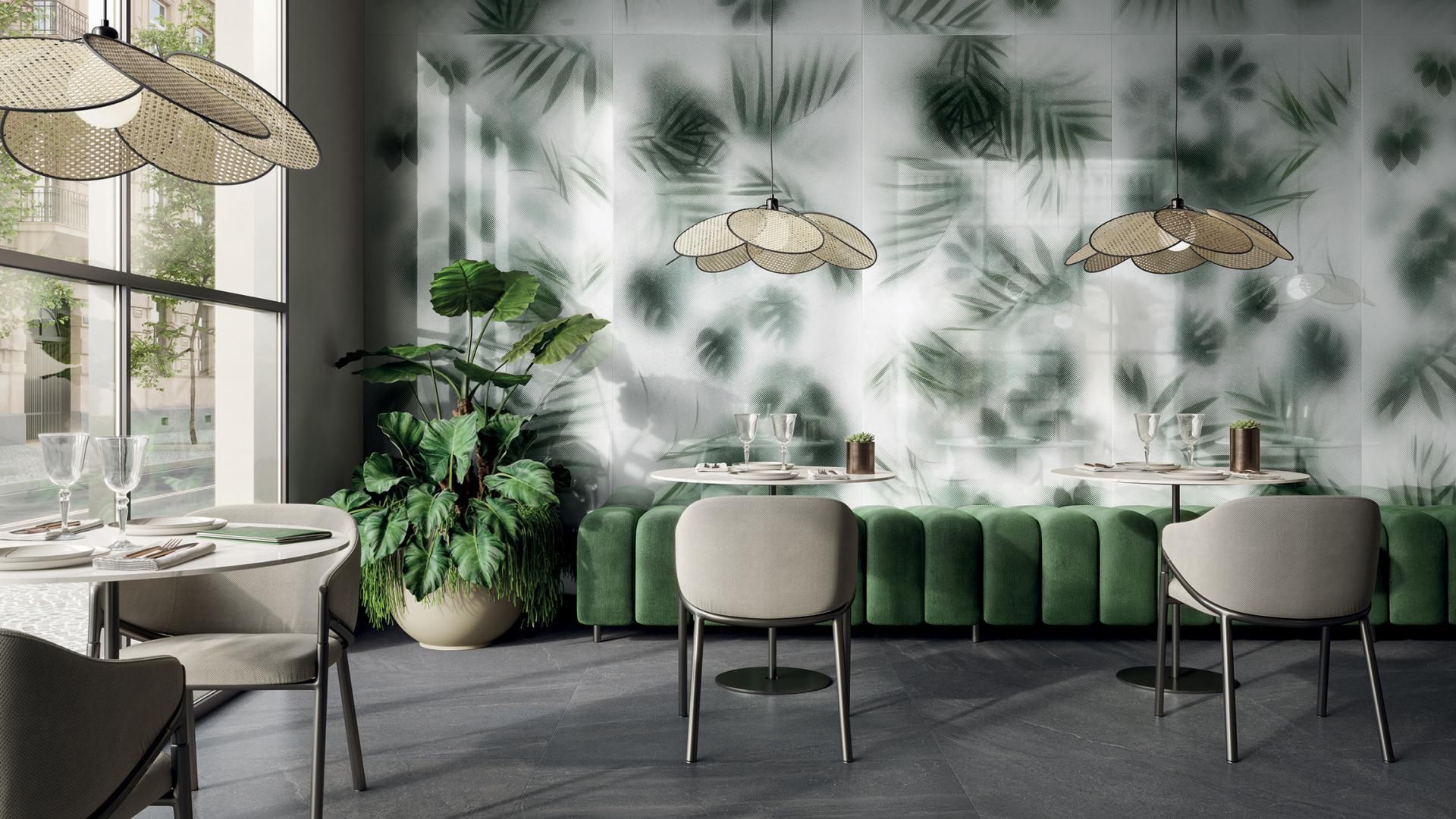 Een restaurant met tafels en stoelen en een muur met bladeren erop.