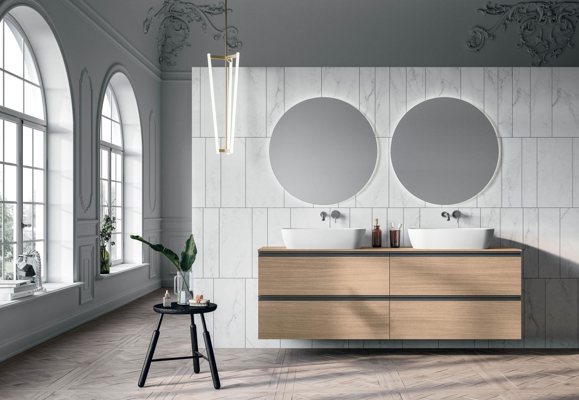 Een badkamer met twee wastafels, twee spiegels en een krukje.
