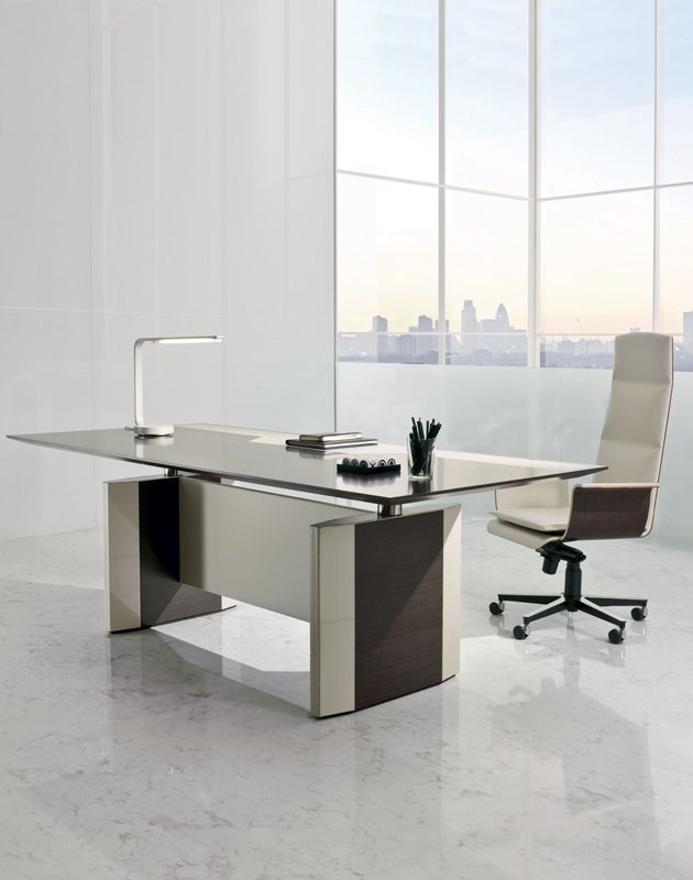 Een kantoor met een bureau en stoel voor een raam