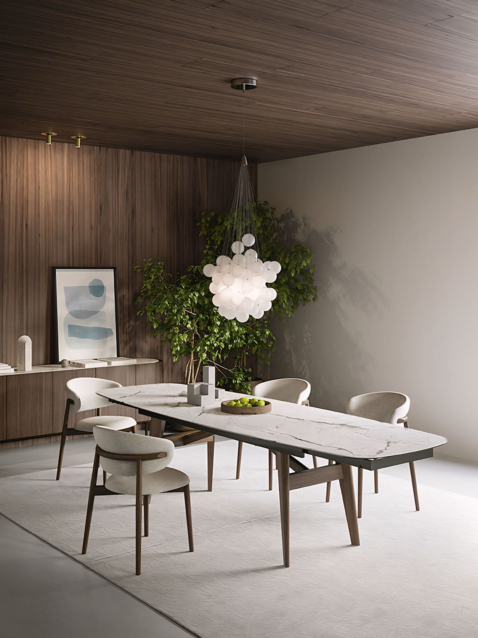 Een eetkamer met een tafel, stoelen en een kroonluchter aan het plafond.