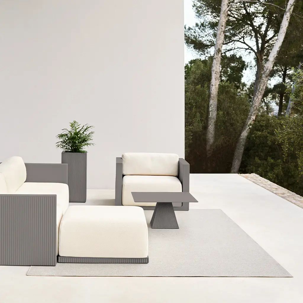 Een terras met een bank, een stoel en een tafel