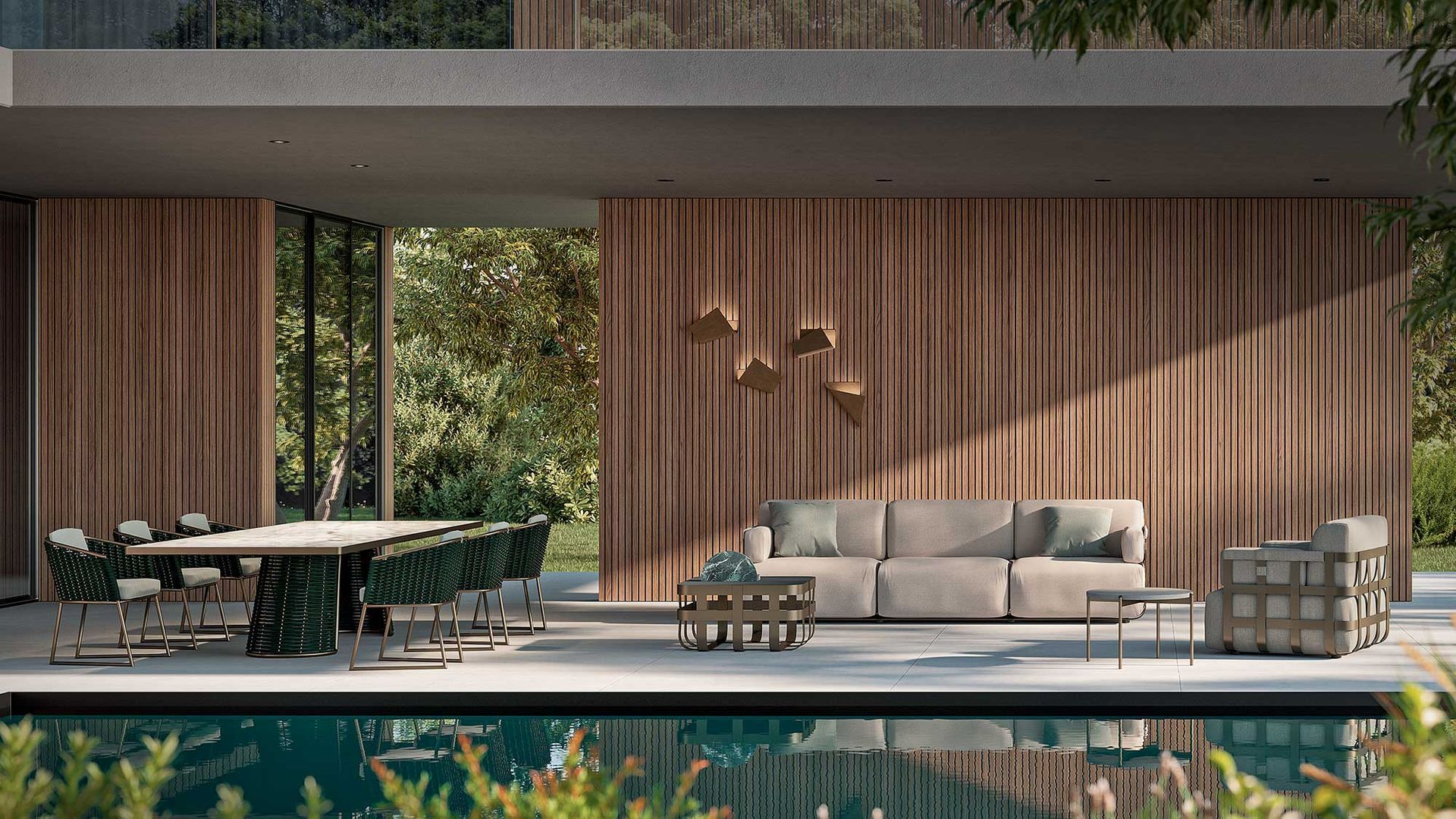 Een terras met een bank, tafel en stoelen naast een zwembad.