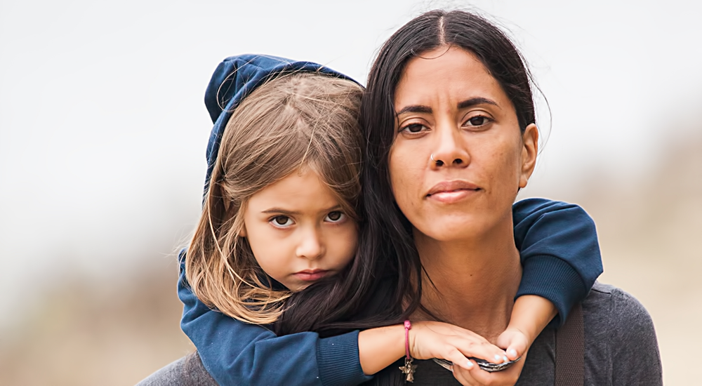A woman is holding a little girl on her shoulders. A woman is holding a little girl on her shoulders.