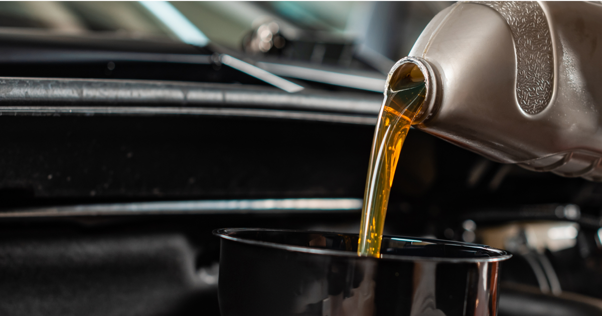 Golden liquid pouring from a kettle into a black cup in a kitchen setting | Madison Automotive