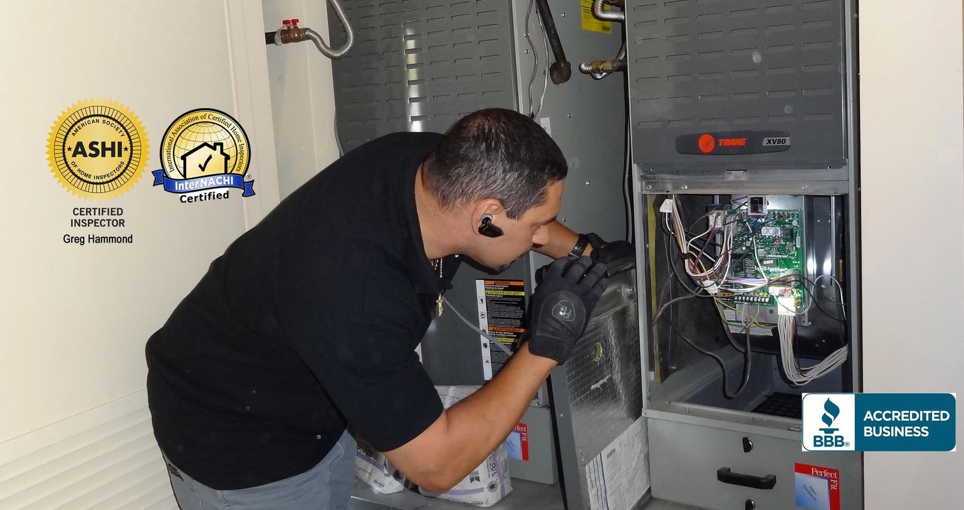 A man is working on an air conditioner in a room.