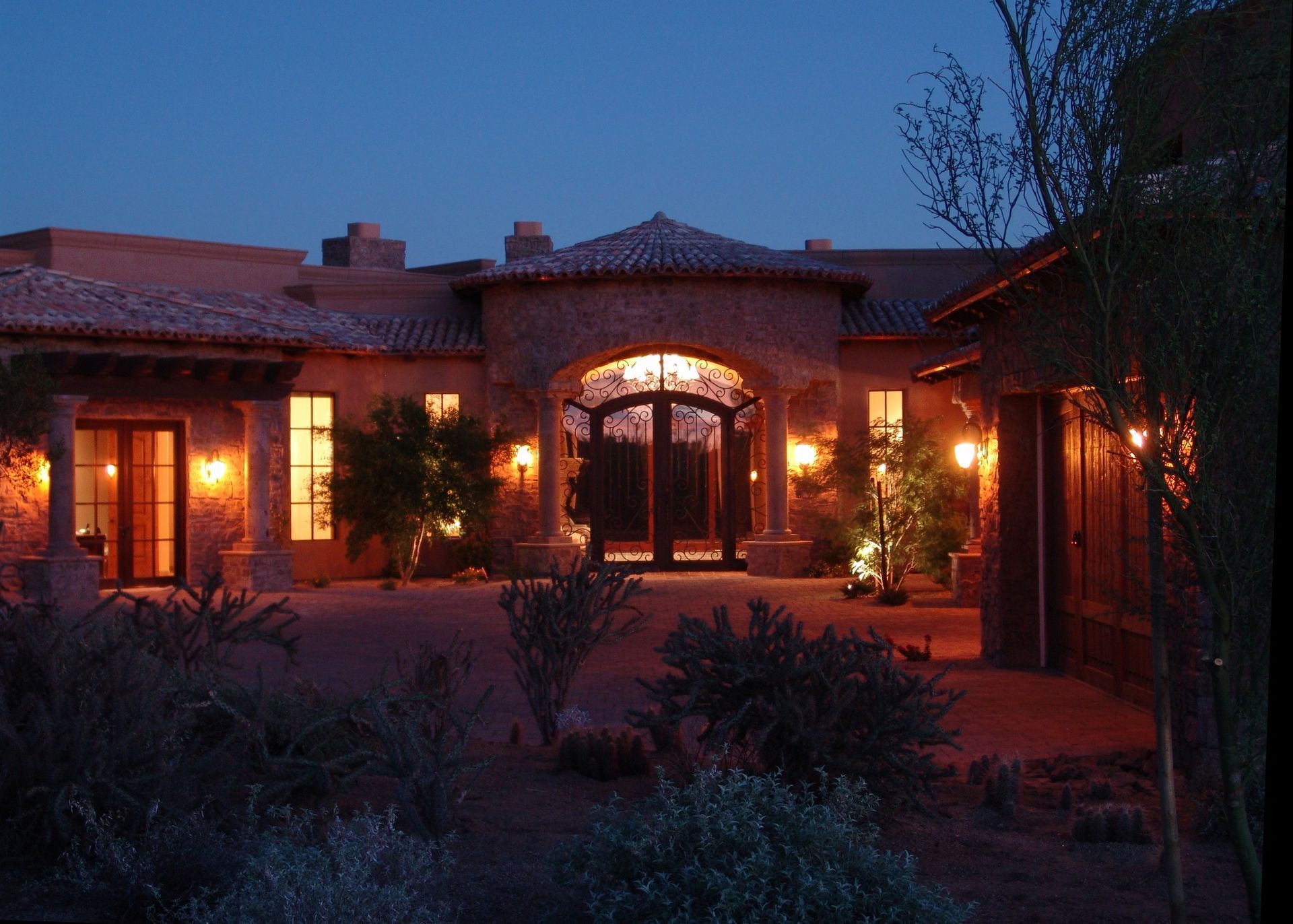 The front of a house is lit up at night