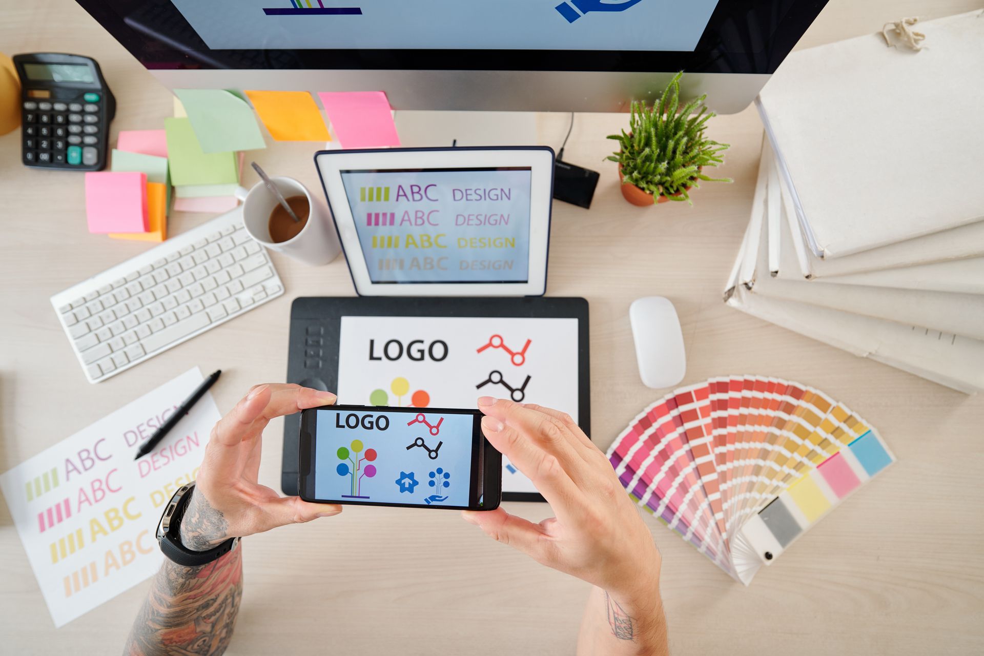 A person is taking a picture of a logo on a cell phone.