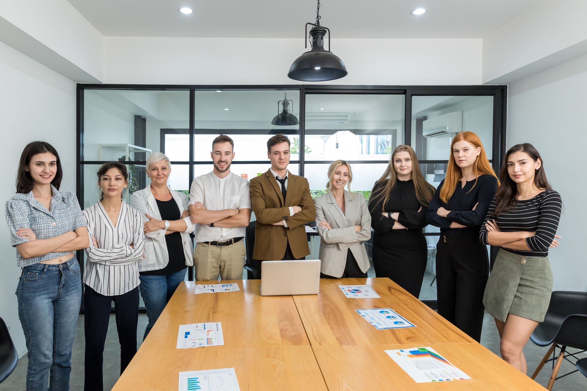 A group of people are posing for a picture in a conference room.