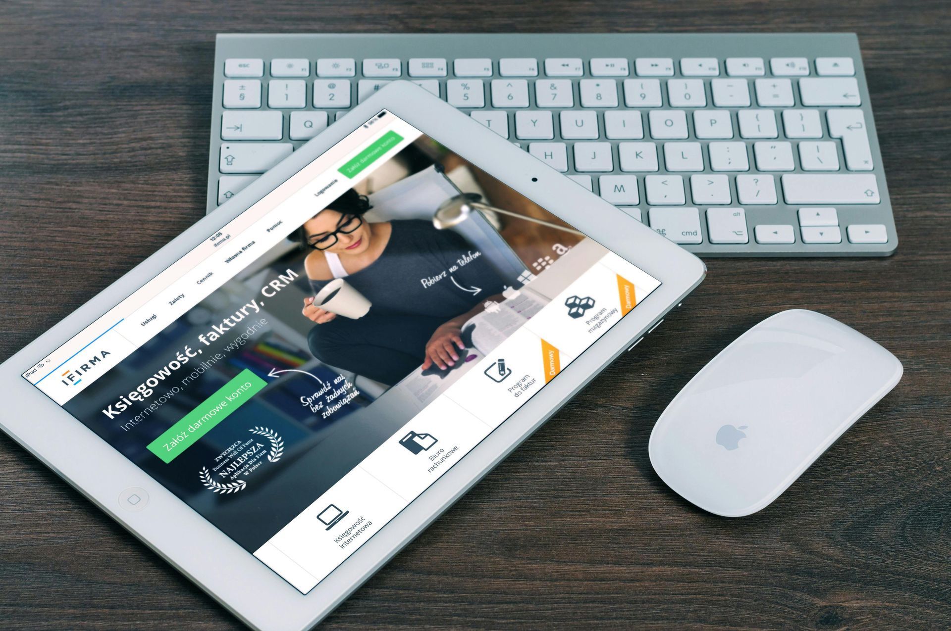 A tablet is open to a website next to a keyboard and mouse