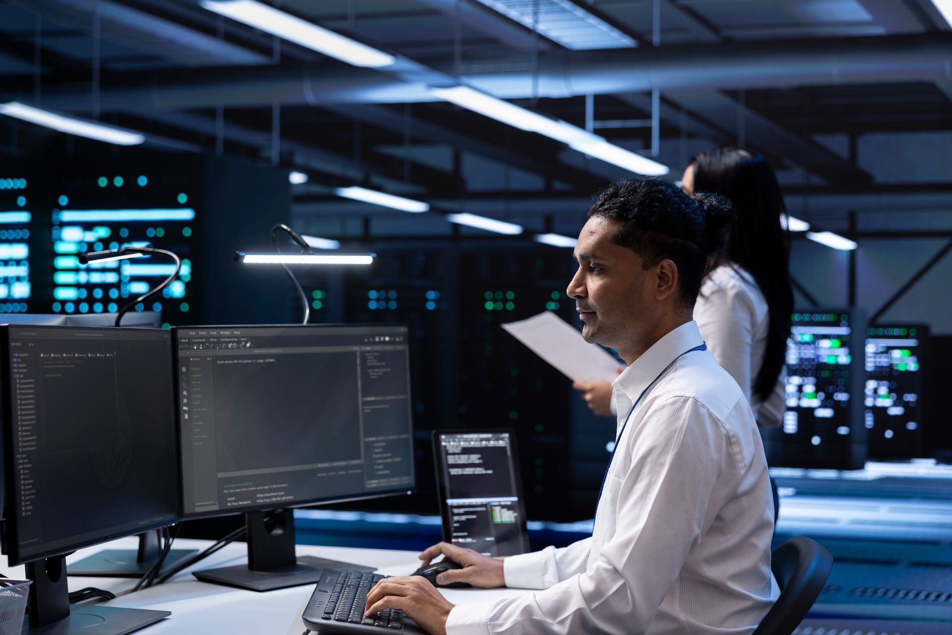 A man is sitting at a desk in front of a computer.