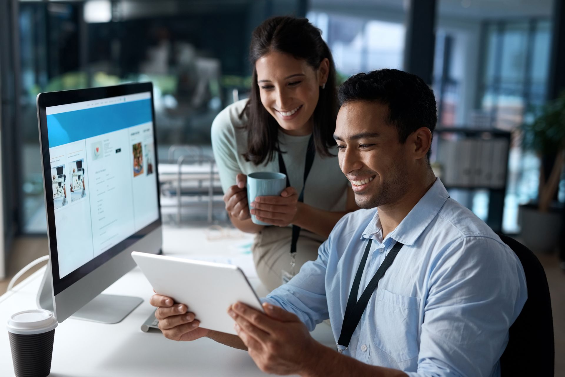 A man and a woman are looking at a tablet computer.