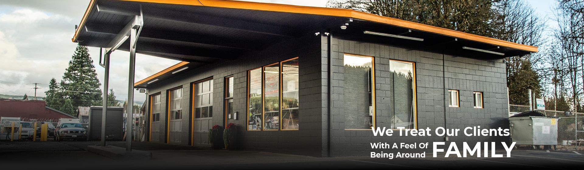 A modern building with large windows and a covered area. Text: 