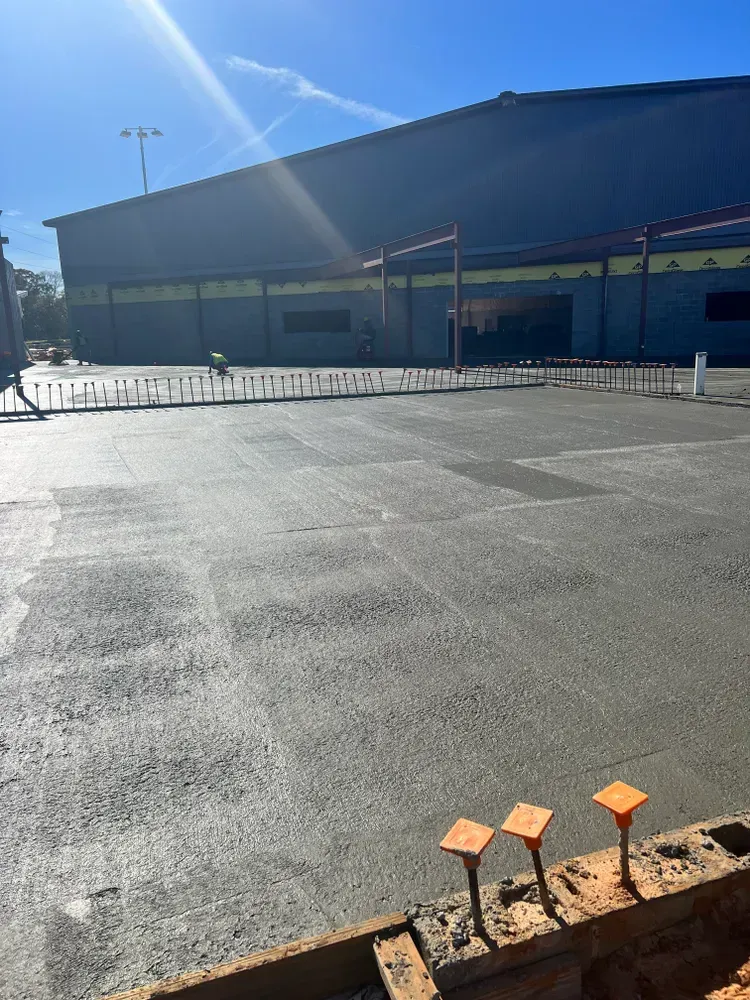 An empty parking lot with a building in the background