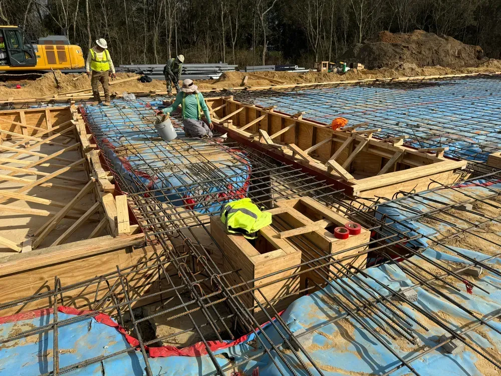 A group of construction workers are working on a construction site.