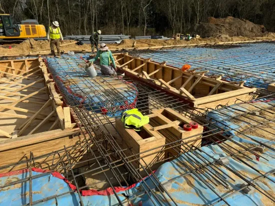 A group of construction workers are working on a construction site.