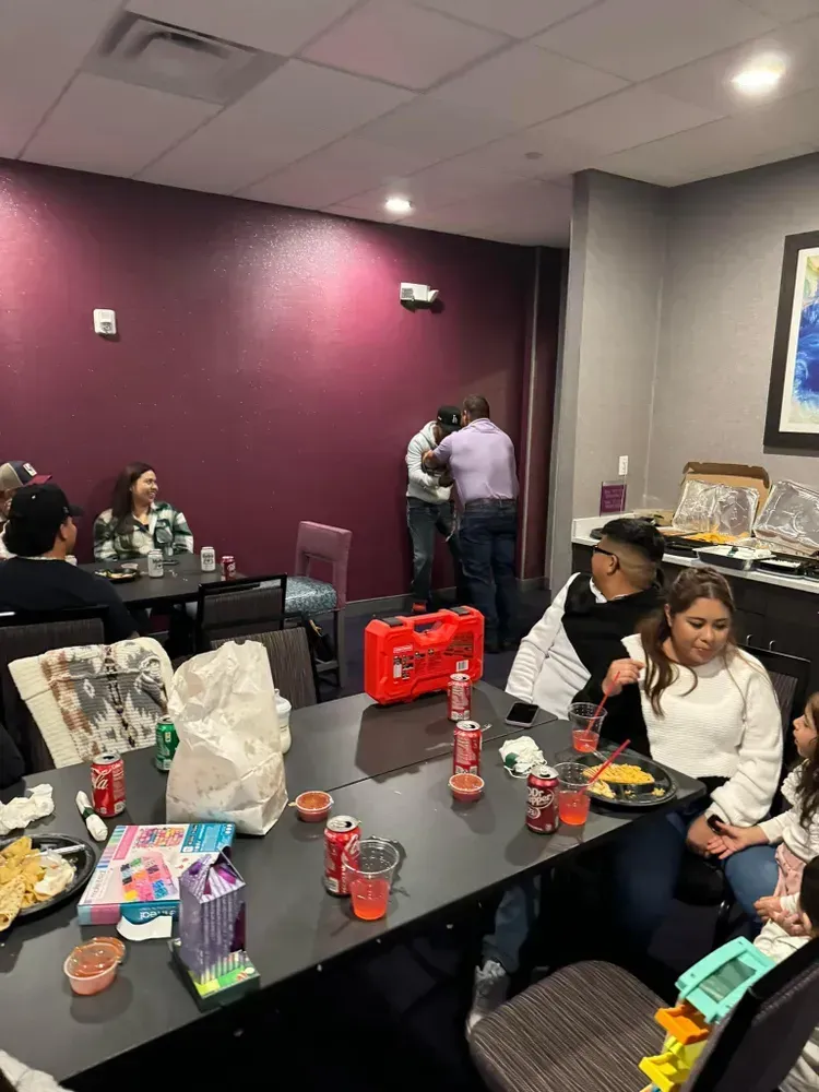 A group of people are sitting at tables in a room.