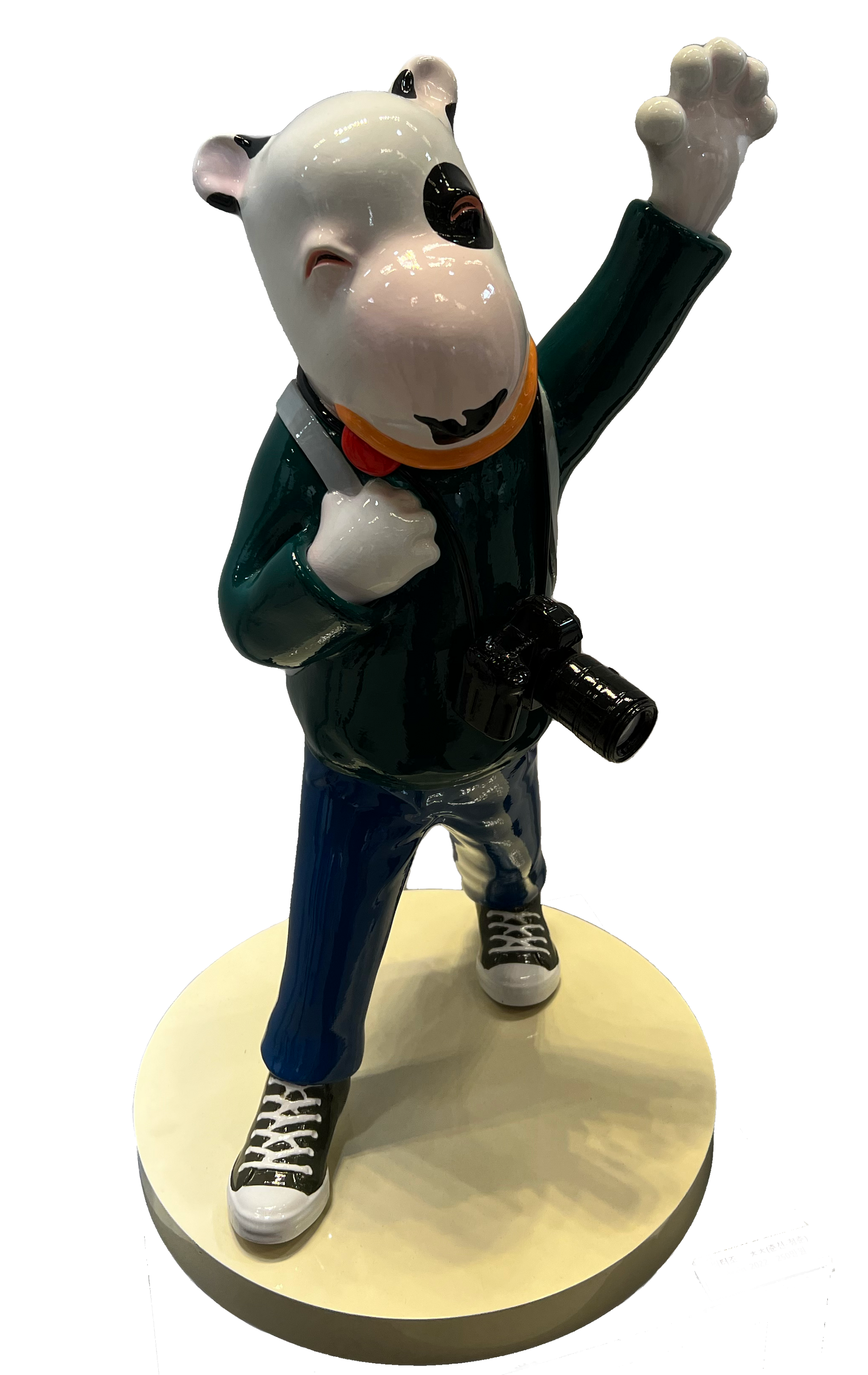 A statue of a dog with a camera on his back