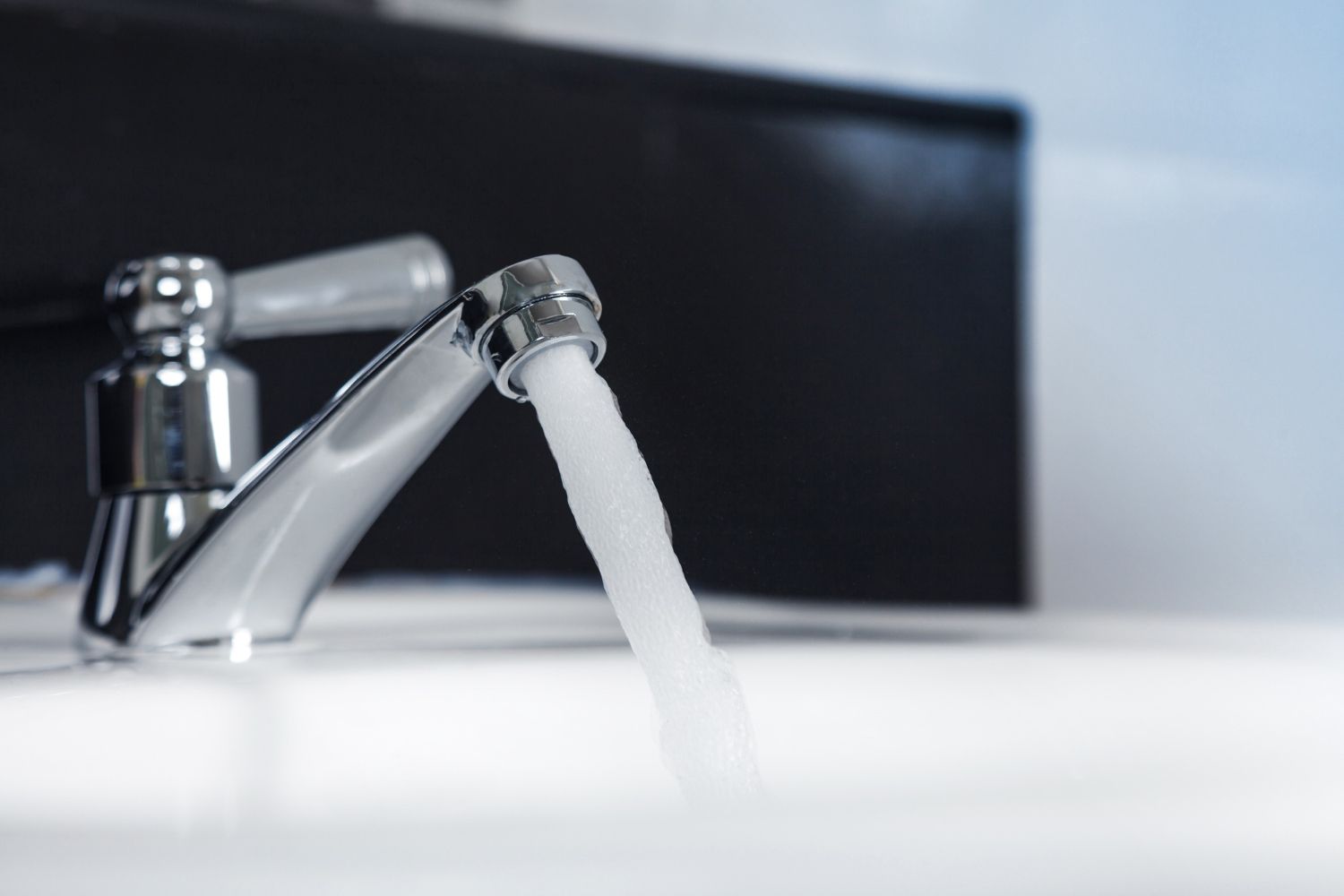 A close up of a faucet with water running out of it