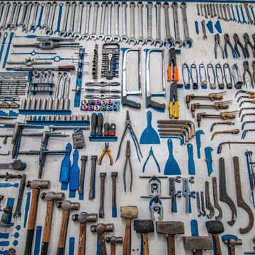 A wall full of tools including hammers and wrenches