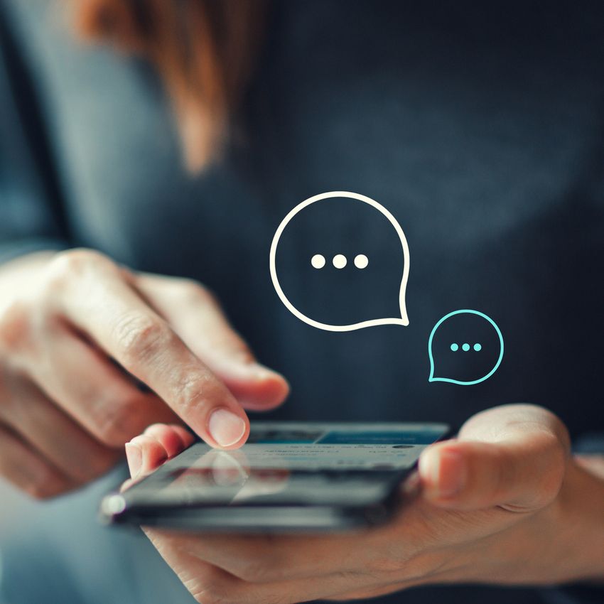 Women's hand typing on mobile smartphone