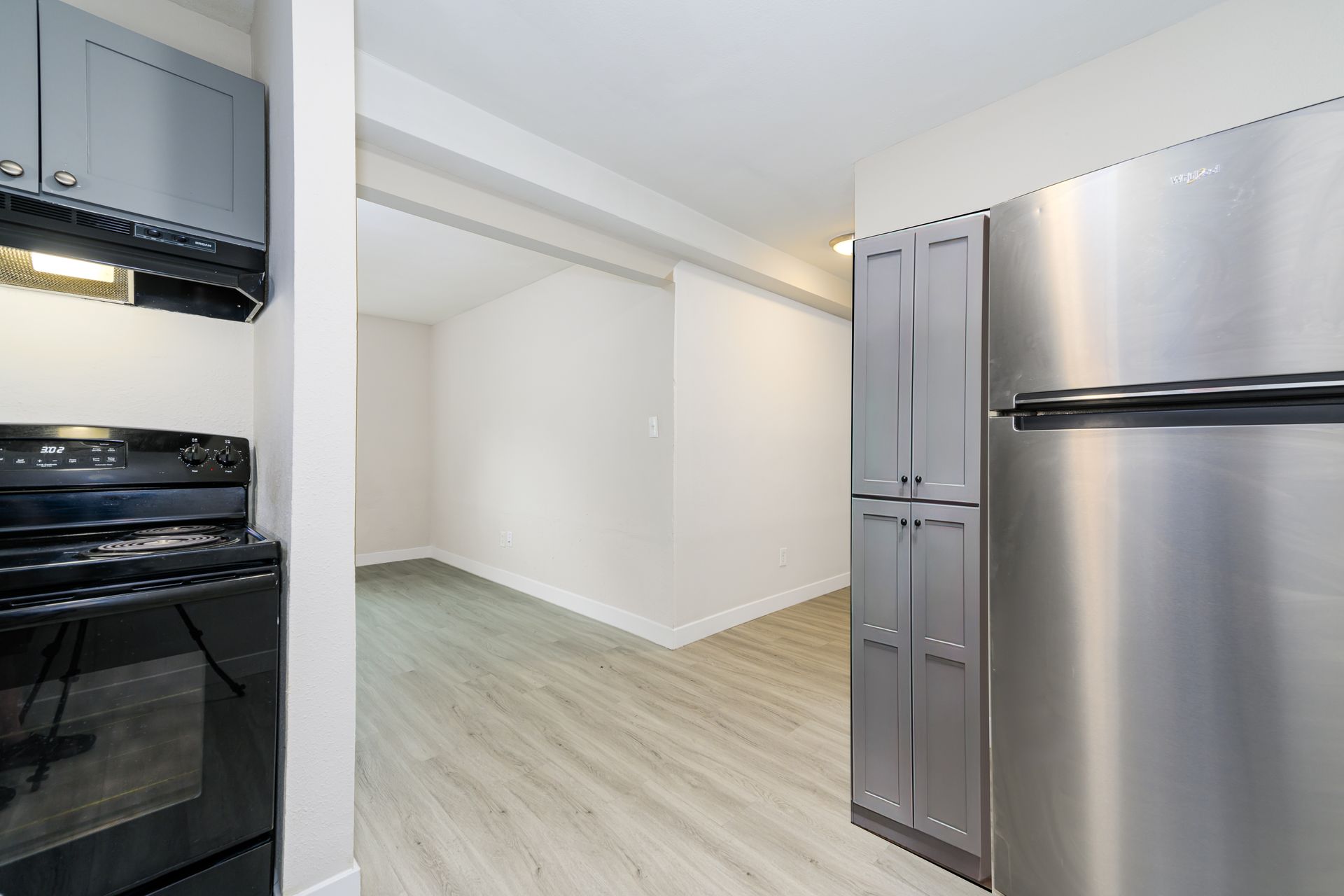 A kitchen with a stainless steel refrigerator and stove.
