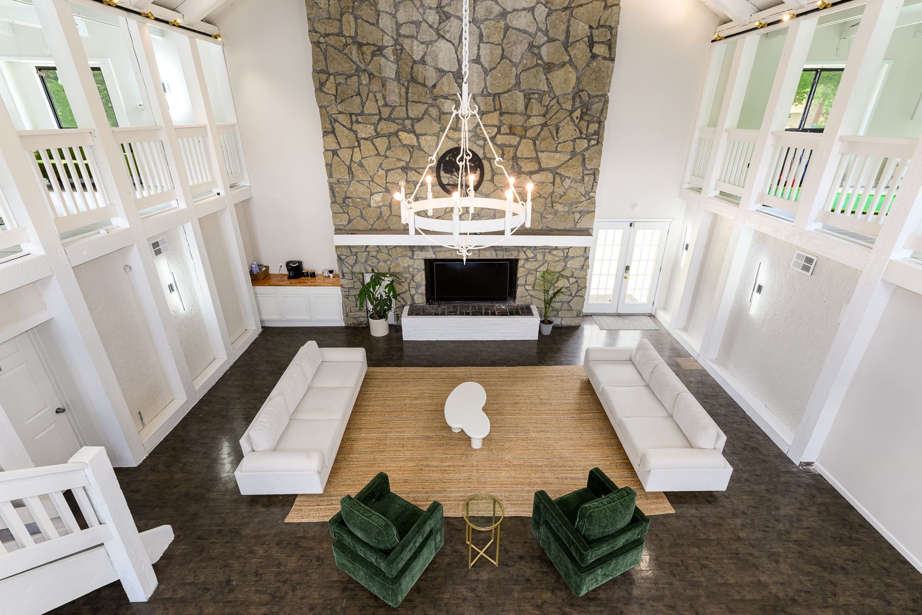An aerial view of a living room filled with furniture and a fireplace.