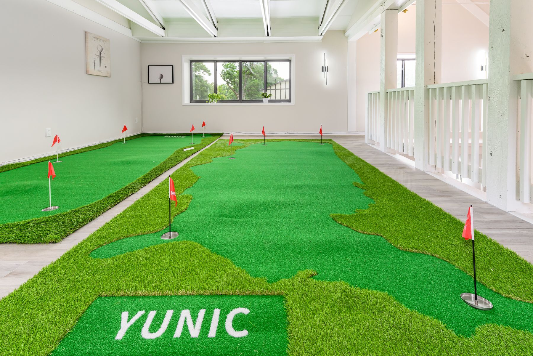 There is a putting green in the middle of the room.