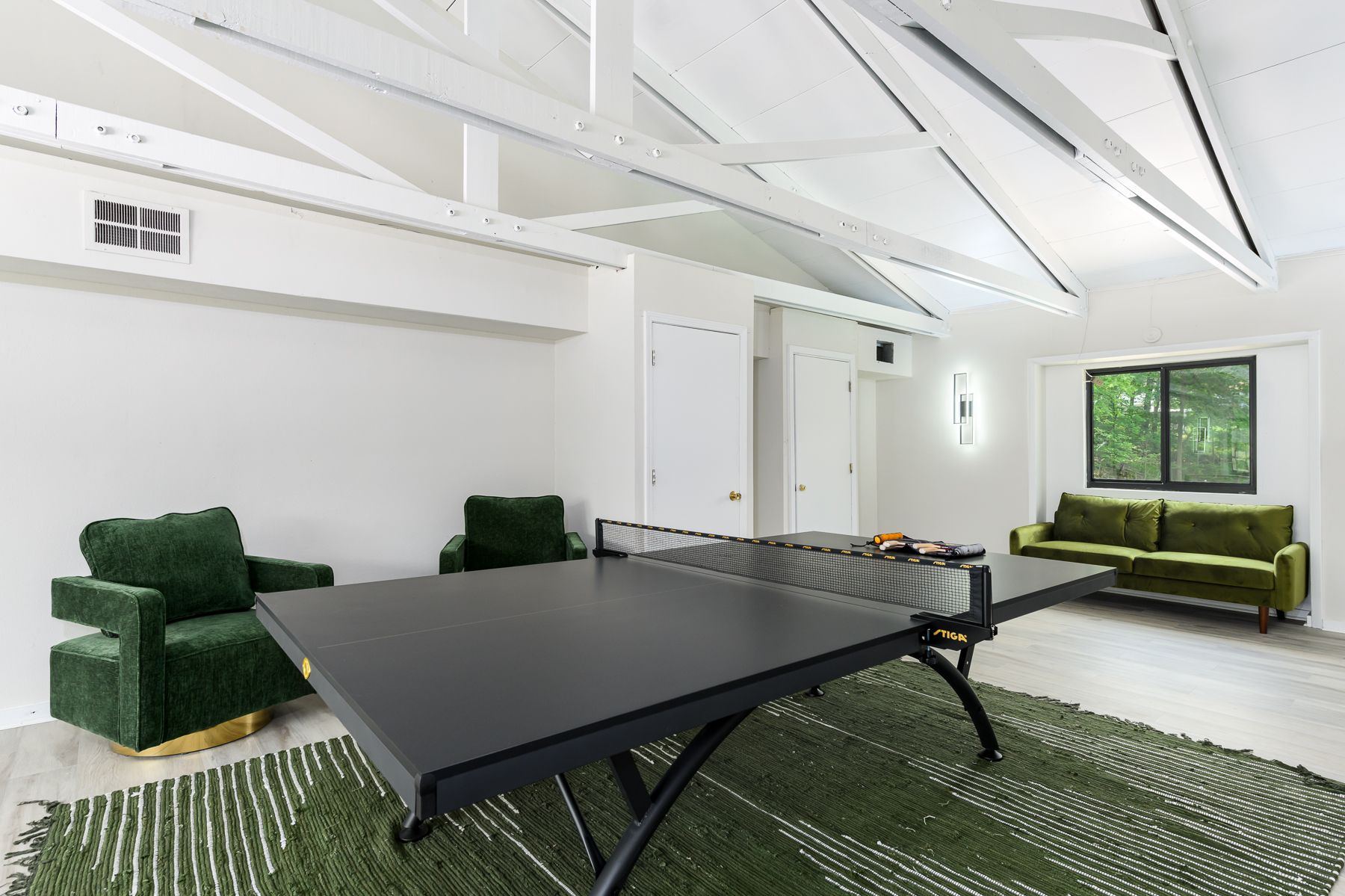 There is a ping pong table in the middle of the room.